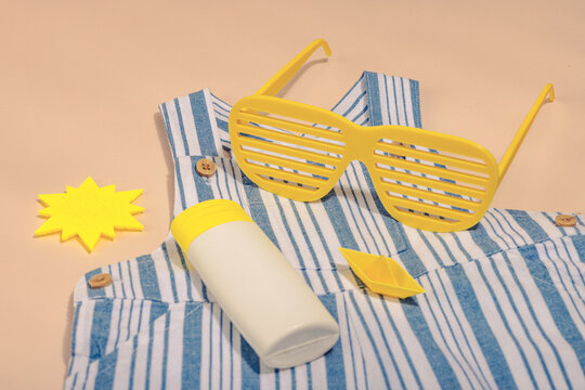 Concept of a safe beach vacation and careful childcare during a holiday. Baby summer flat lay