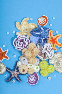 Summer crocheting concept. Handmade coral reef, marine style, underwater animals, blue background