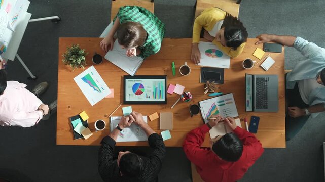 Top view of smart project manager invite businessman talking about marketing idea while investor listening t meeting room. Male worker receive and start to explain about marketing plan. Convocation.