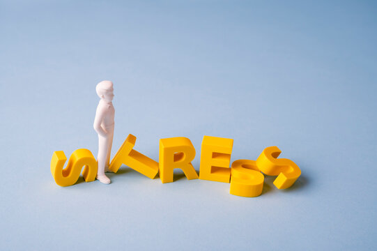 Work stress, pressure and burnout concept with businessman among fallen STRESS letters