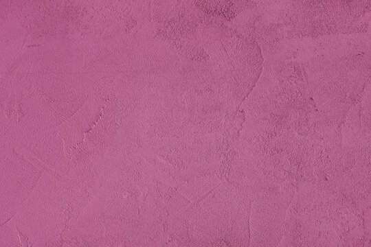 Pink stucco wall, uneven plaster surface, painted distressed concrete texture background. Abstract grunge backdrop, wallpaper for design, construction design element