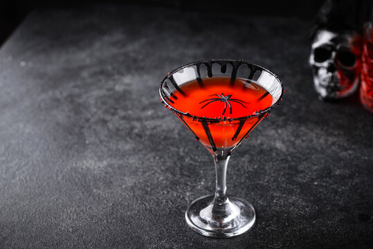 Spooky red Halloween martini cocktail with spider