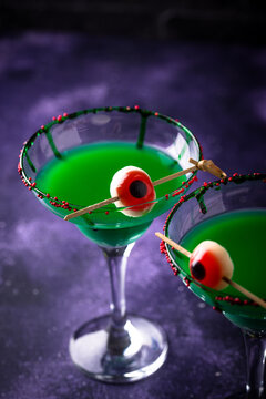 Spooky green Halloween monster cocktail with eyeball