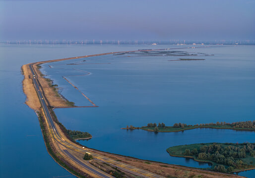 Houtribdijk curves through Dutch lakes at blue hour