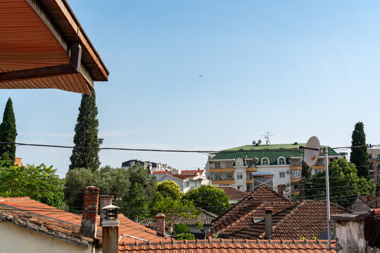 Podgorica, Montenegro - 20 June 2025: View of residential rooftops and buildings under a clear blue sky.