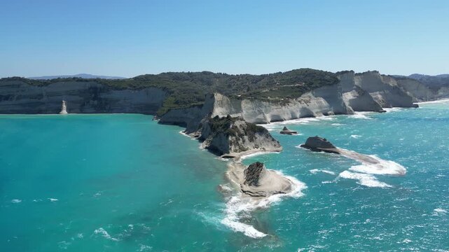 4K Static Aerial Drone View of Cape Drastis White Limestone Rock Formations, Sea Stacks, Dramatic Coastal Cliffs and Crystal Clear Turquoise Ionian Waters Along the Spectacular Northwest Coast of Corf