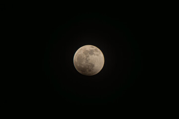 Full moon illuminating the dark night sky, symbolizing mystery, celestial beauty, cosmic wonder, space exploration, and lunar cycles in astronomy © VICTOR A ARGUELLO