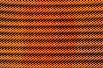 Obraz premium Close-Up of Orange-Red Textured Surface with Hexagonal Pattern