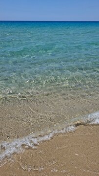 stunning beach day with crystal-clear water and golden sand at solanas beach, sardinia, italy