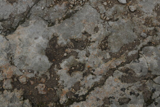 Muted Gray Earthy Cracked Stone Texture Background Rugged Granular Surface for Abstract Design Backdrops with Ample Copy Space Macro Detail