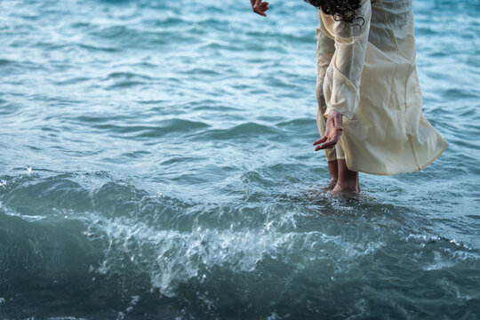 Jesus Christ reaches out to save the Apostle Peter from drowning in the sea. A biblical scene of a miracle on the water.