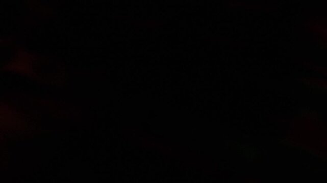 Soft Gradient Abstract Black Motion Graphics Background with Subtle Dark Red and Green Light Leaks Evoking Mystery Digital Space and Ethereal
