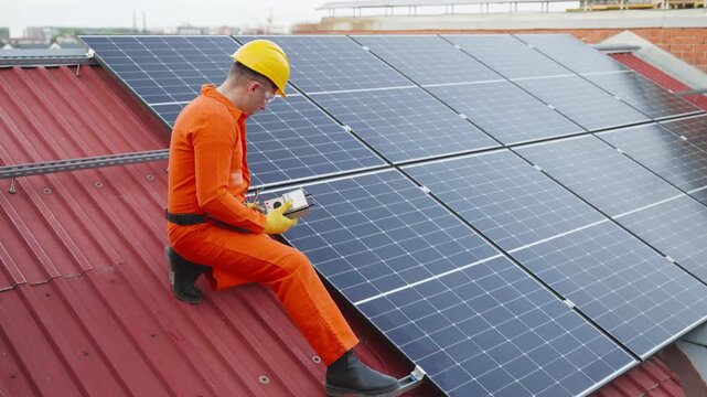 Technician measuring solar panel performance on roof