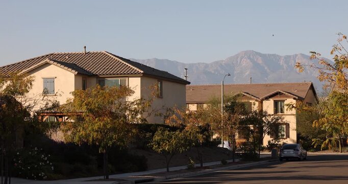 Afternoon sun shines on single family homes in the Declezville neighborhood of Fontana, California, USA.