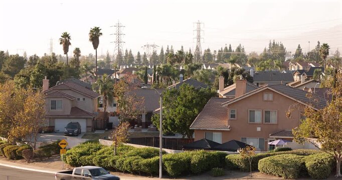 Afternoon sun shines on single family homes in the Declezville neighborhood of Fontana, California, USA.
