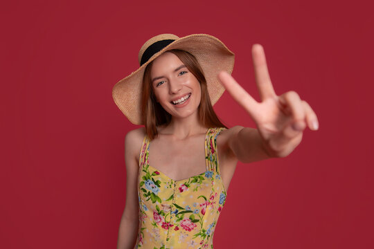 Happy Summer Woman Reaching Forward With Peace Sign