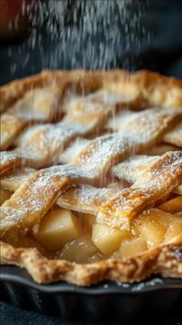 Close-up of Powdered Sugar Falling on a Lattice Apple Tart