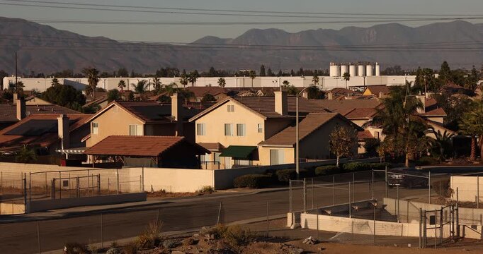 Afternoon sun shines on single family homes in the Declezville neighborhood of Fontana, California, USA.