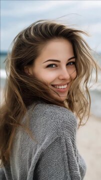 Smiling Woman with Long Hair and Knit Sweater on a Beach