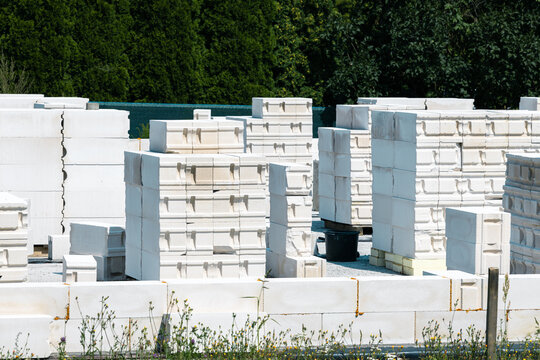 Aerated concrete blocks stacked on a construction site for a single family house. Precise modular elements support fast masonry work and modern building methods.