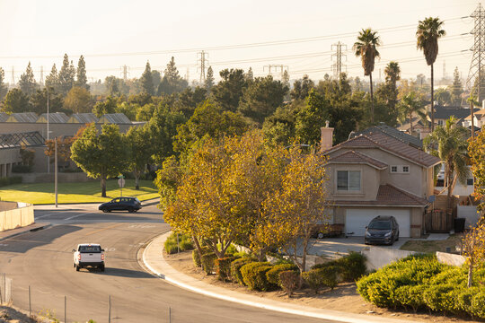 Afternoon sun shines on single family homes in the Declezville neighborhood of Fontana, California, USA.