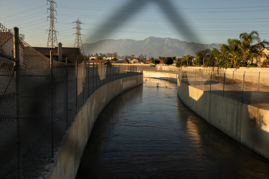 Water flows in a channel in the Declezville neighborhood of Fontana, California, USA.