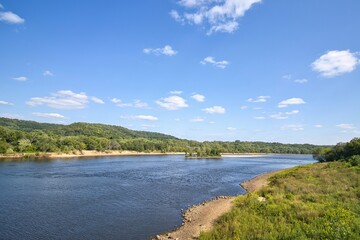 On a sunny summer day, the view of a peaceful Wisconsin River flowing near Sauk City, Wisconsin.