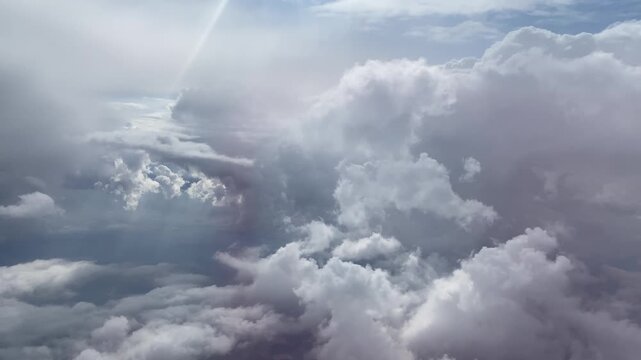 Video of clouds in the sky through the window of a flying plane.