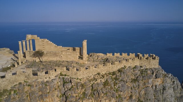 Drone shot, Acropolis of Lindos, Late afternoon light, Temple of Athena Lindia, Ruins of an ancient building on a cliff overlooking the sea, Archaeological site, Lindos, Rhodes, Dodecanese, Greek Islands, Greece
