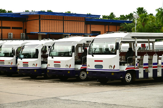 Electric park shuttles car or sightseeing car are lined up in the parking area.