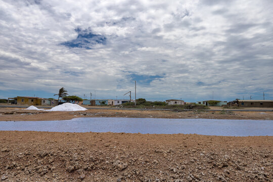 Vibrant Pink Water of Cumaragua Salt Mine Under Cloudy Sky in Falcon Venezuela, Tropical Travel Destination