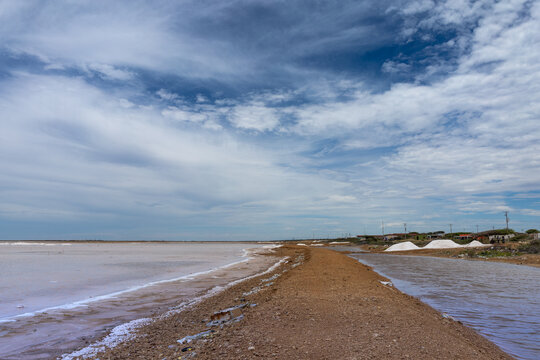 Vibrant Pink Water of Cumaragua Salt Mine Under Cloudy Sky in Falcon Venezuela, Tropical Travel Destination