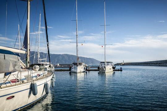 yachts docked in modern marina with shore power and water pedestals