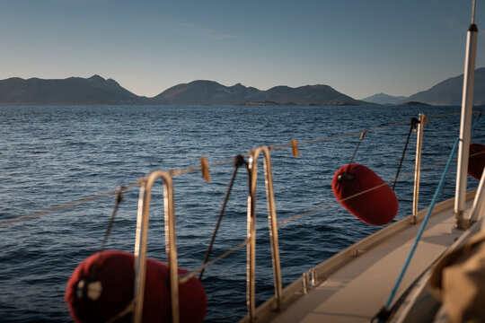 View from cockpit of sailing yacht heeling in open sea during summer travel