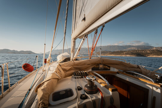 View from cockpit of sailing yacht heeling in open sea during summer travel