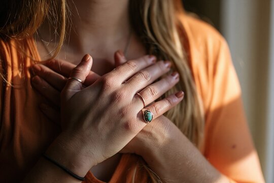 Gratitude and love gesture by a woman with hands on chest for healing and peace