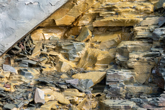 Quebec, Canada, 28 July 2026 : Water flows over and through layered rock formations, creating a textured natural landscape.