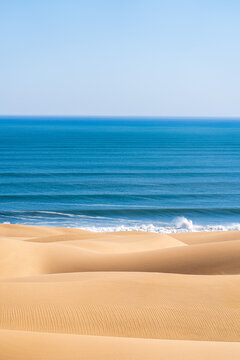 Golden Coastal Sand Dunes Meeting the Blue Ocean