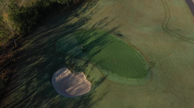 Aerial drone view of SAM Tuyen Lam Golf Club in Da Lat, Vietnam, showcasing lush fairways surrounded by pine forests and mountain scenery in the scenic Tuyen Lam Lake area.