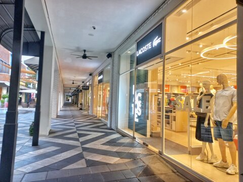 Karawang, Indonesia - August 11, 2026: Modern retail storefront of Lacoste luxury fashion boutique at Summarecon Villaggio Outlets commercial shopping mall destination.