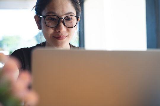 Confident woman with hopeful eyes working on laptop, focused remote work and modern professional lifestyle concept.