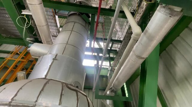 Complex oil and chemical processing facility with dense pipe networks, industrial valves, machinery, and structural engineering elements, representing energy production, process automation, industrial