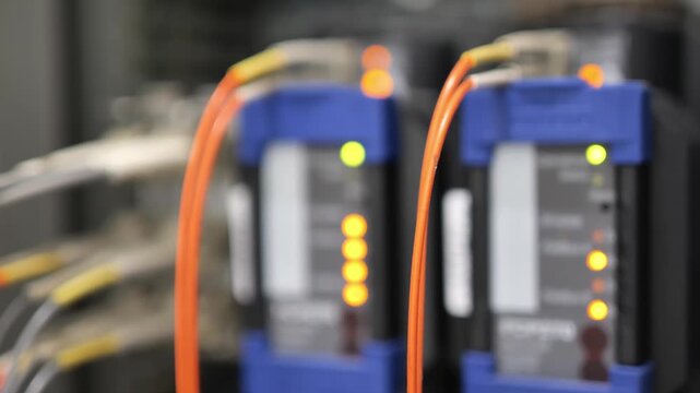 Fiber optic communication converter transmitting digital data signals through optical fiber cable, illustrating high speed telecommunications, network connectivity, data transmission, and advanced com