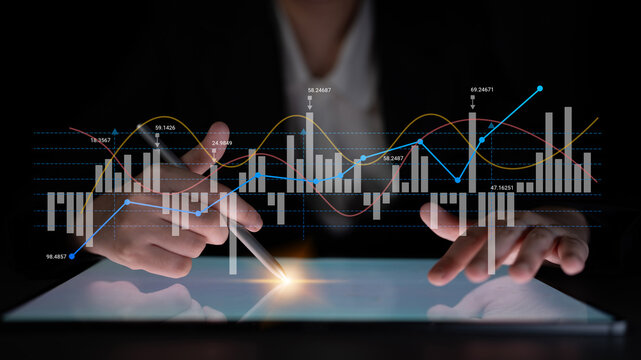 A business professional studies stock market trends on a tablet using a digital pen, showcasing finance analysis with vibrant graphs and data for smart investment decisions. Ledger