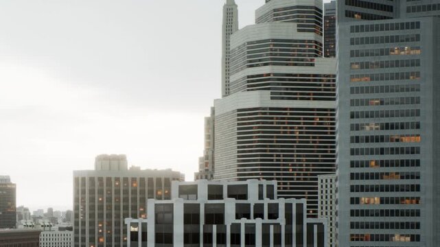 Buildings rise against an overcast sky in a busy city. The structures display a mix of modern architecture. Light reflects from numerous windows as evening approaches.