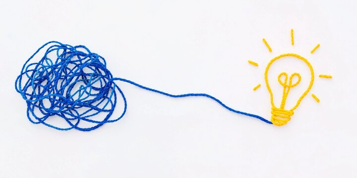Minimalist conceptual artwork showing a tangled blue string transforming into a straight path toward a yellow light bulb, symbolizing clarity, ideas, creativity, and solutions.