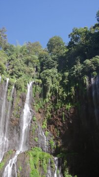 Waterfalls cascading down mossy mountain cliffs