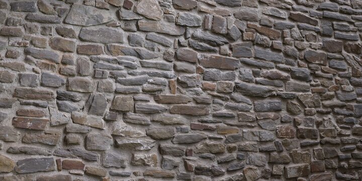 Natural brown stone wall texture showing stacked rustic slate bricks uneven masonry surface architectural background full frame photo setup design