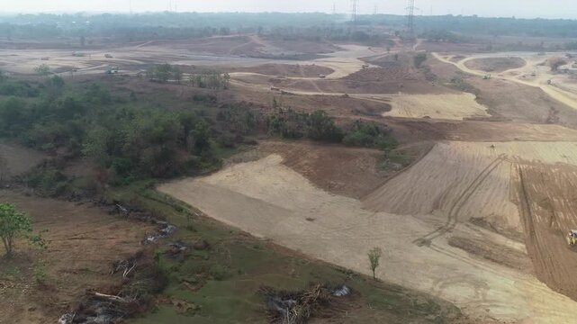 Aerial drone footage of a large-scale construction site, extensive land development, and infrastructure progress.