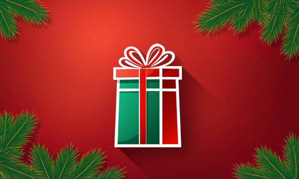 striped red and green gift box with red bow and pine branches in corners on red surface